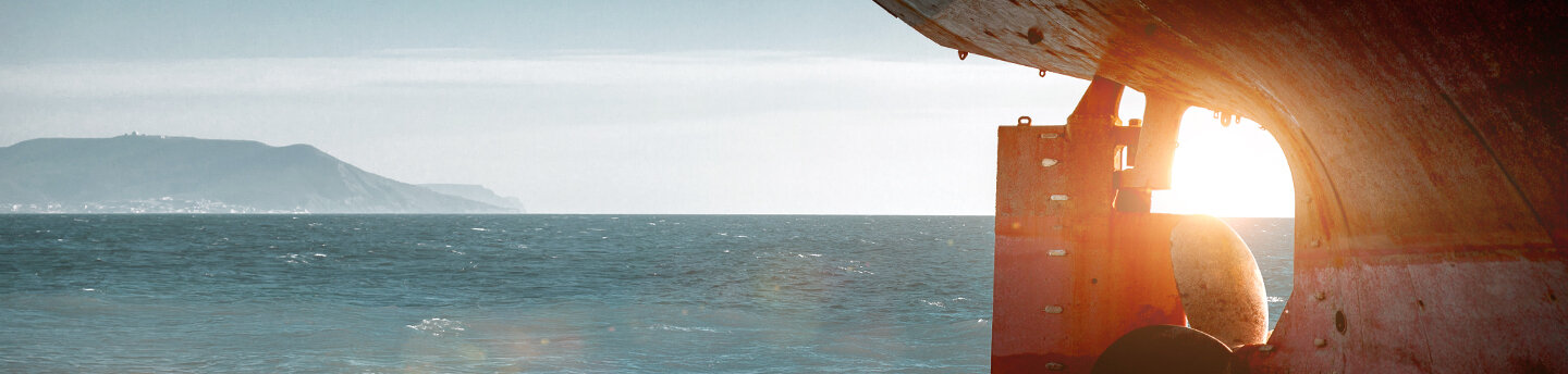 Stern of a cargo ship on the open sea.